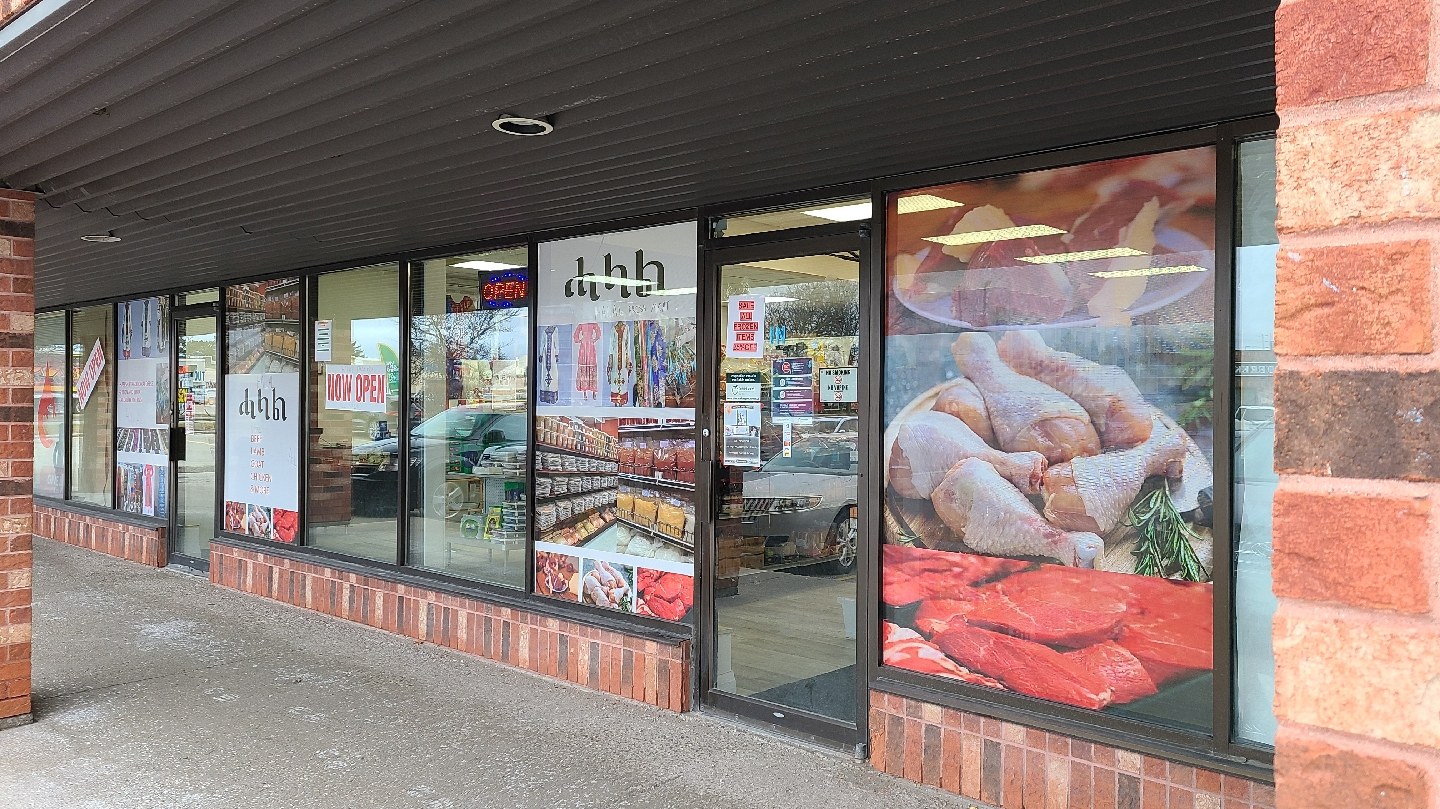 Bright, modern interior of Helal Freshmeat & Supermarket with fresh produce and halal meat counter